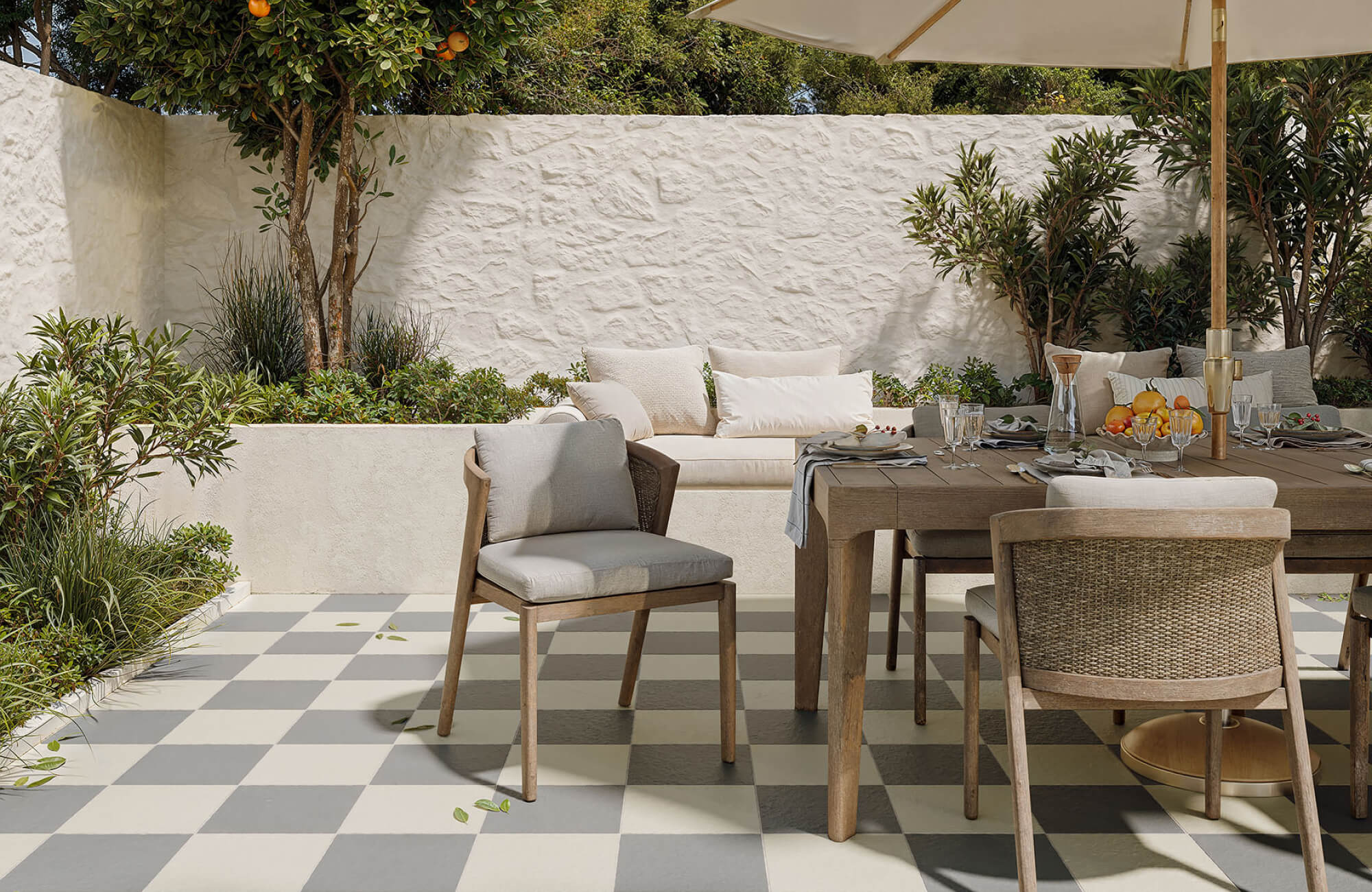 null Patterned outdoor tile floor defining a dining area, using contrasting tones to add visual interest while maintaining functional durability.