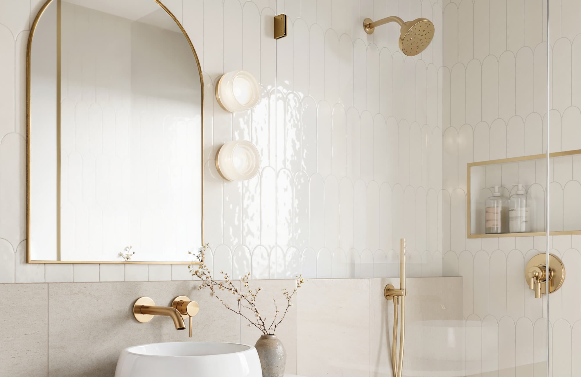 null Elegant bathroom featuring scalloped white tiles with a glossy finish, accented by gold fixtures and an arched mirror.