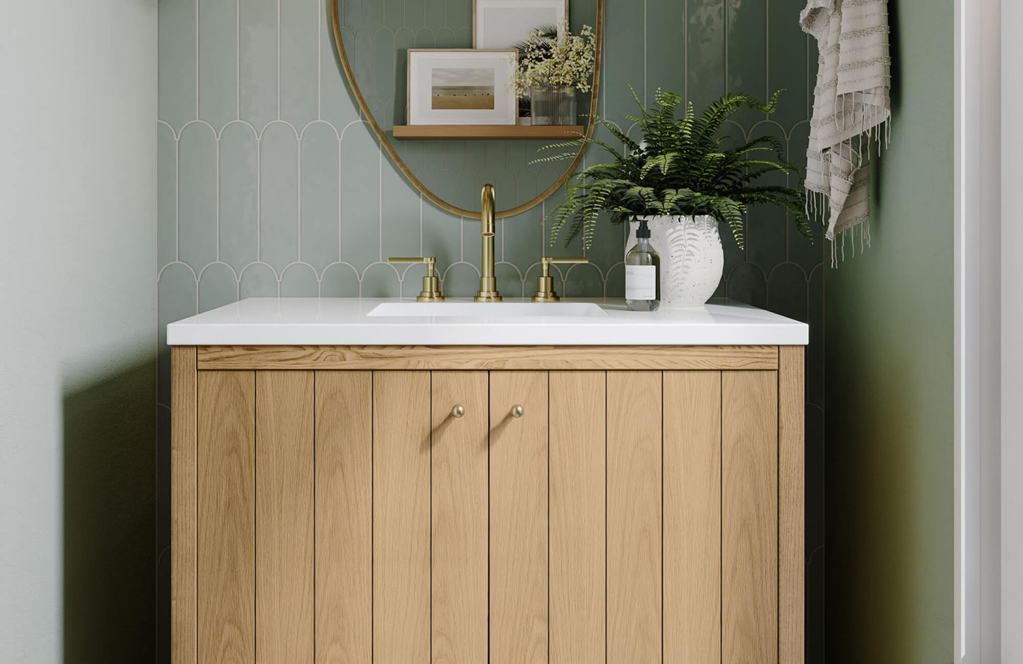 Compact wood vanity with flat panel doors and a white sink top, styled against soft green tile in a narrow powder room.