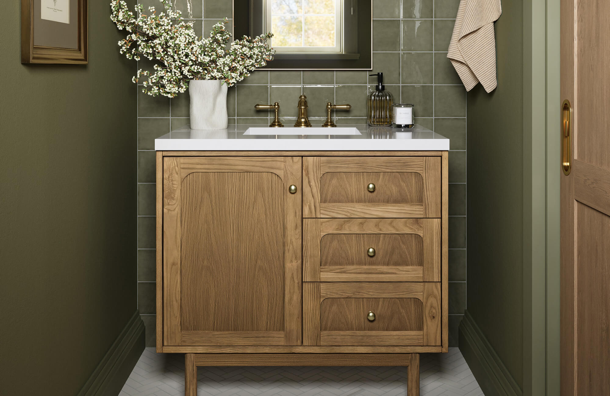 Single-sink wood vanity with drawers and cabinet storage, set between dark green walls with tile backsplash in a tight space.