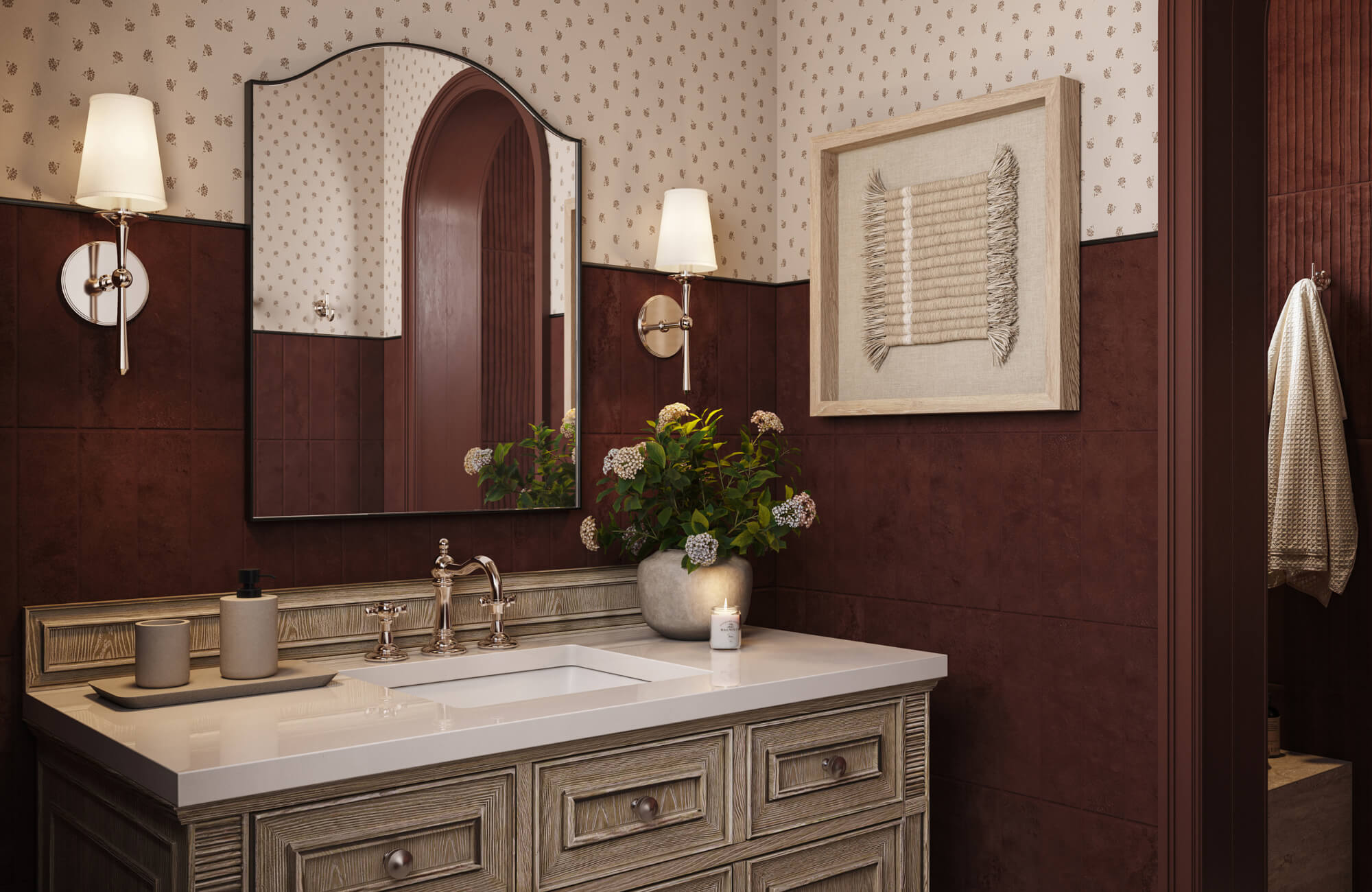 null Warm-toned bathroom with wood vanity, arched mirror, patterned wallpaper, and framed textured textile artwork on the wall.