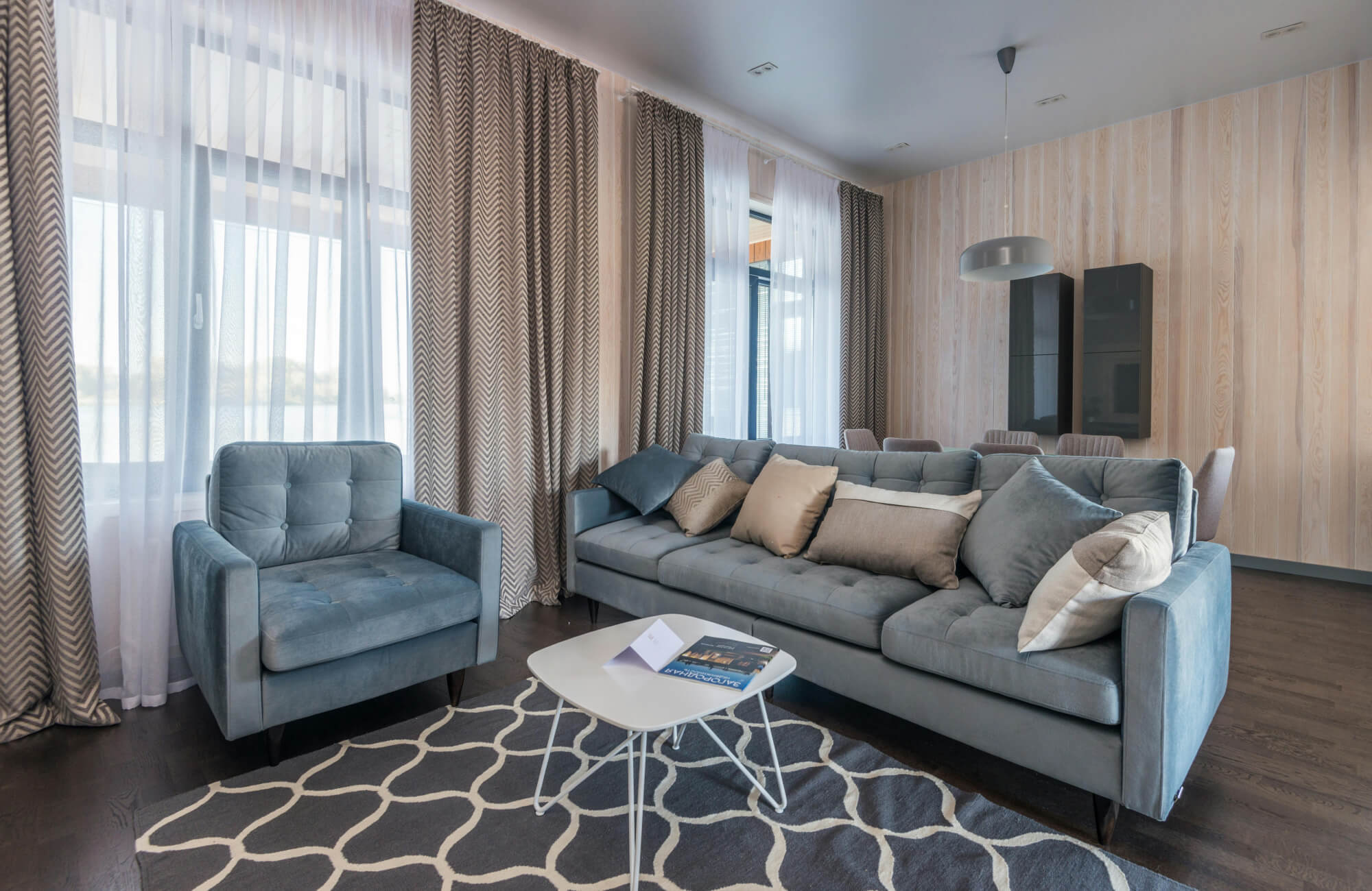 null Soft neutral striped wallpaper brightens this airy living room with a calm, balanced feel.