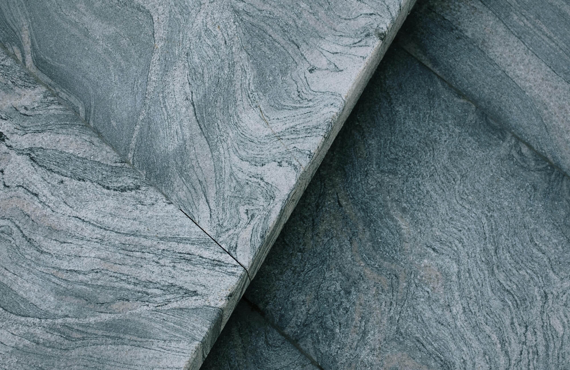 null Luxury vinyl plank surface designed to mimic natural gray stone with subtle swirling patterns.