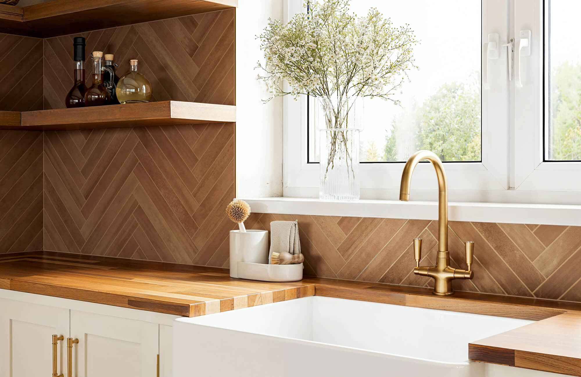 null Kitchen backsplash featuring wood-look tiles in a herringbone pattern, paired with wood counters and a gold faucet.