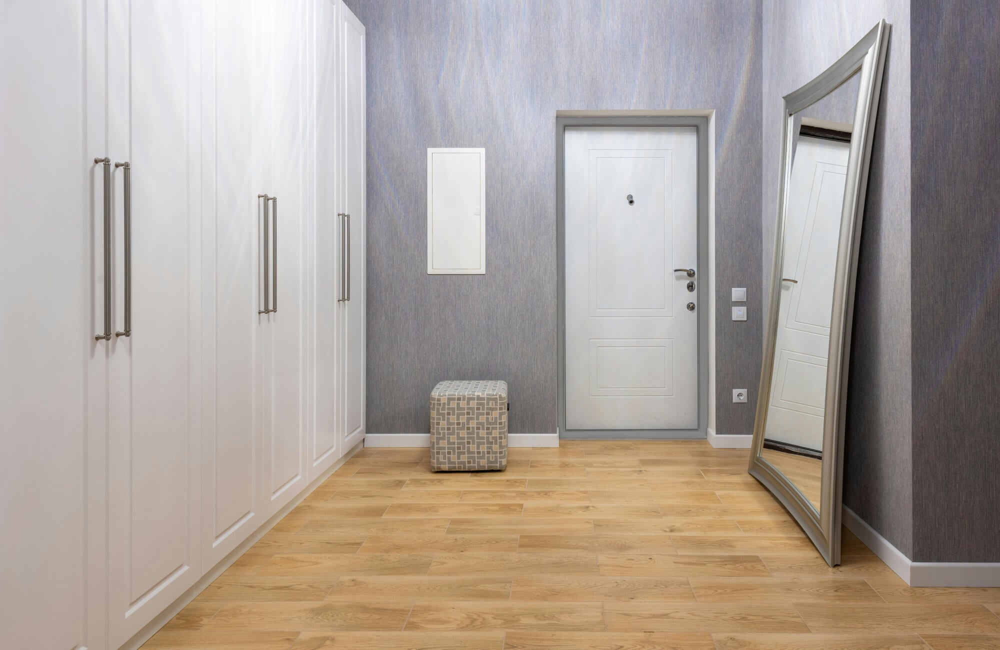 null Tall leaning mirror at the end of a hallway to extend sightlines and create a strong visual endpoint.