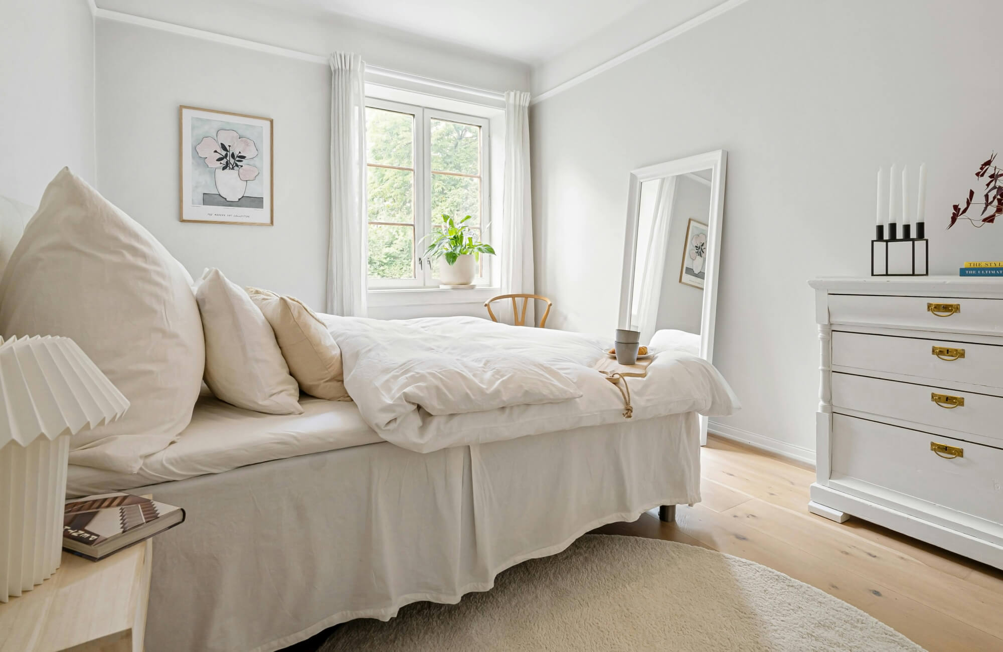 null A full-length mirror leaned in a bedroom corner near a window to reflect soft light and expand visual space.