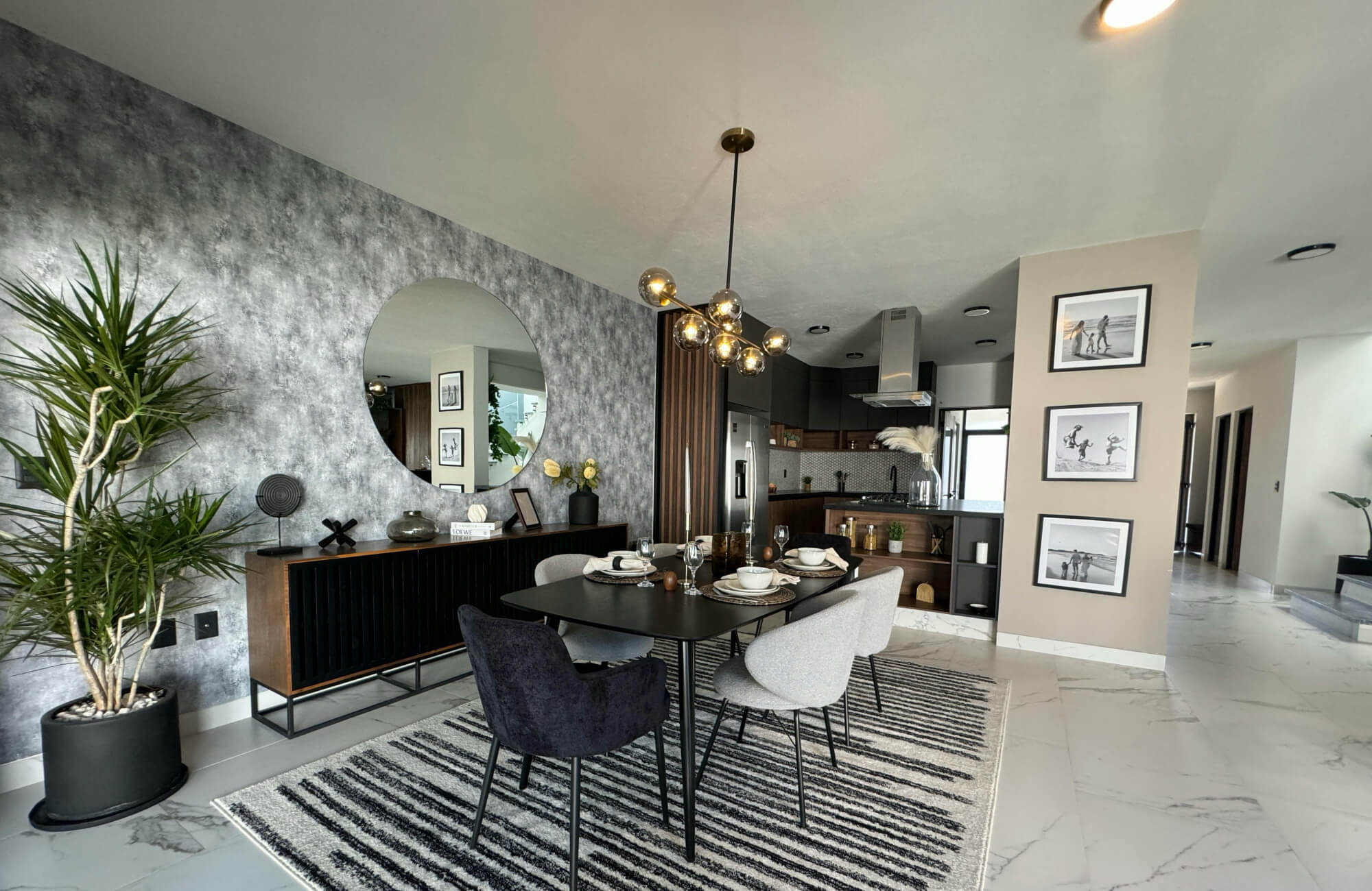 null Round mirror in an open-plan dining room reflecting the dining zone while maintaining separation from nearby areas.