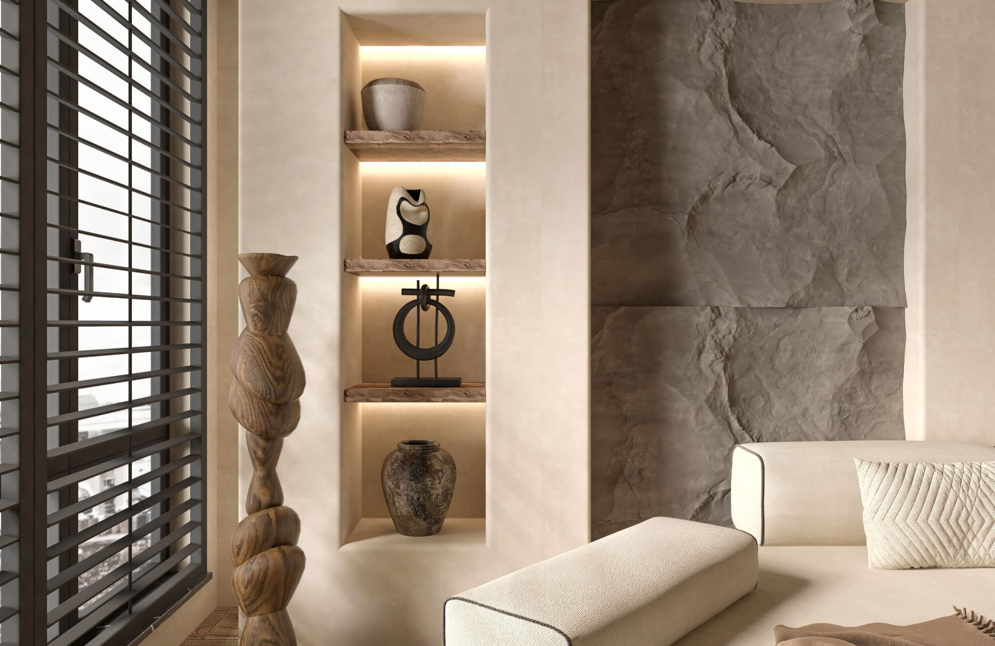 Warm beige living room with a wooden totem figure, built-in shelves holding black metal, cream, and brown ceramic decor, and a textured gray feature wall.