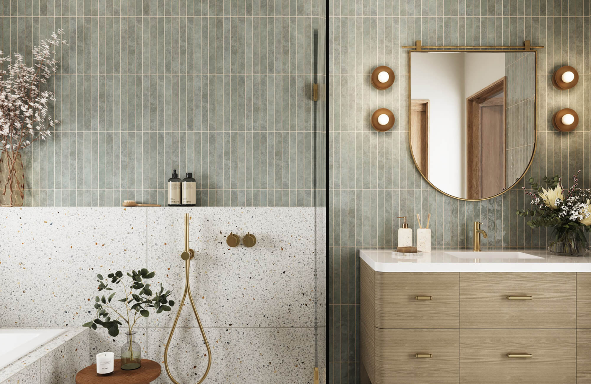 Arch mirror mounted above bathroom vanity, paired with wall sconces for balanced lighting