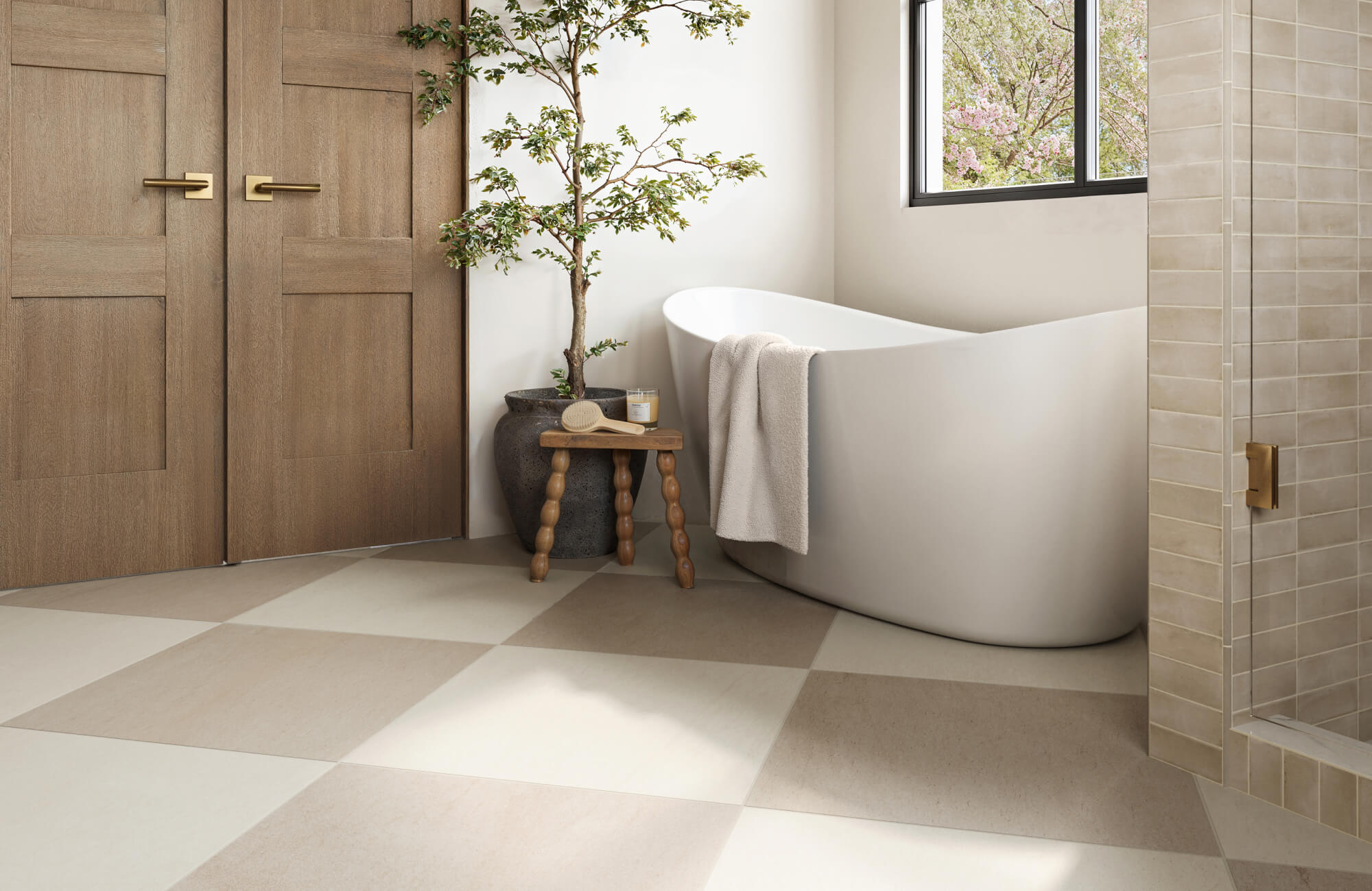 null Serene bathroom with large checkered porcelain tiles in warm beige tones, paired with a modern freestanding tub and natural wood accents.