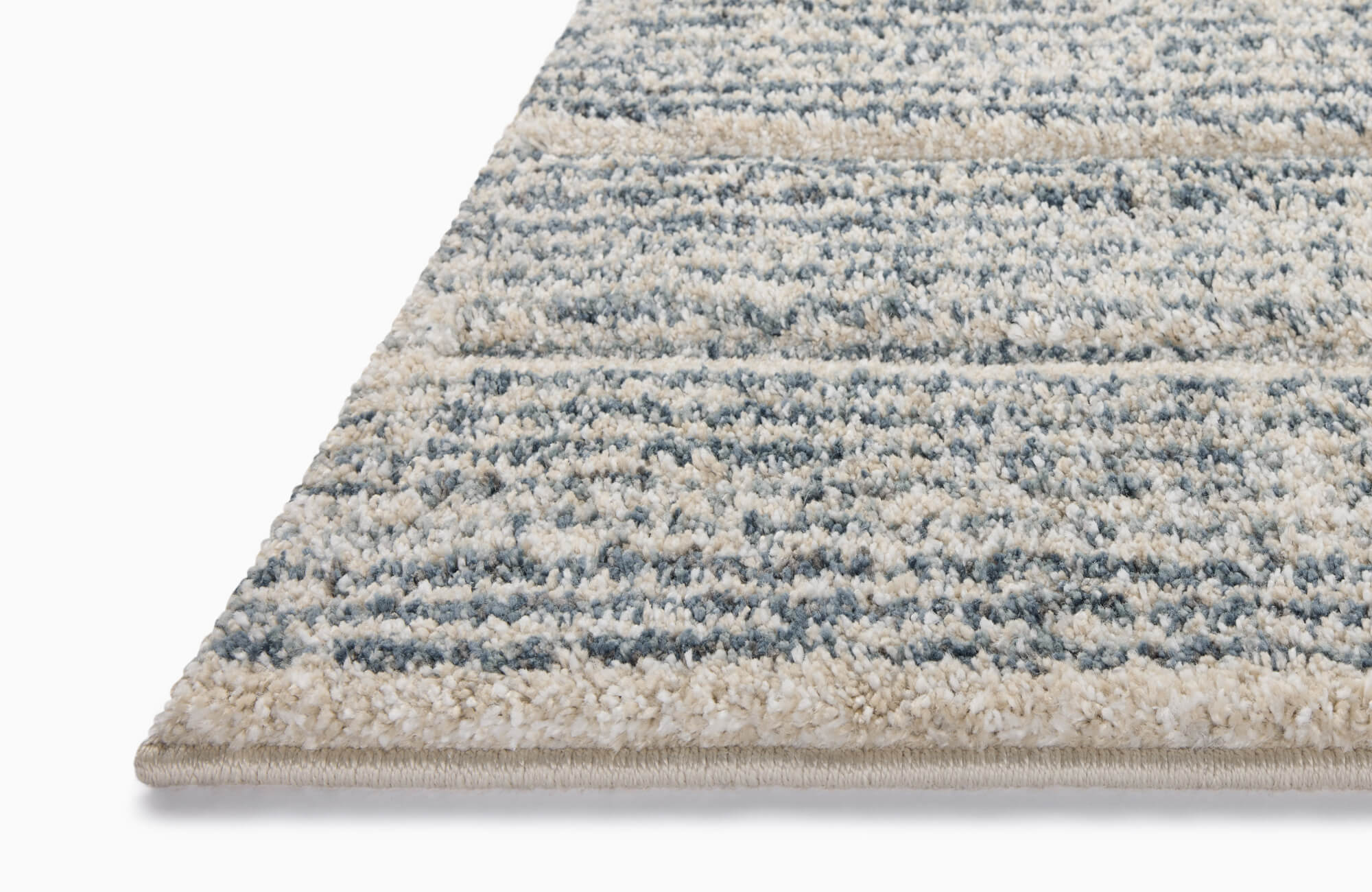 Plush polypropylene area rug with a textured striped pattern in soft blue and ivory tones, offering a cozy and modern touch to any space.