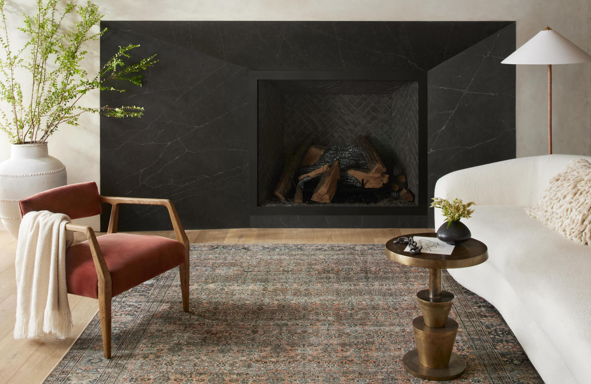 Person vacuuming a modern textured rug with a geometric pattern in neutral tones, enhancing a clean and stylish living space.