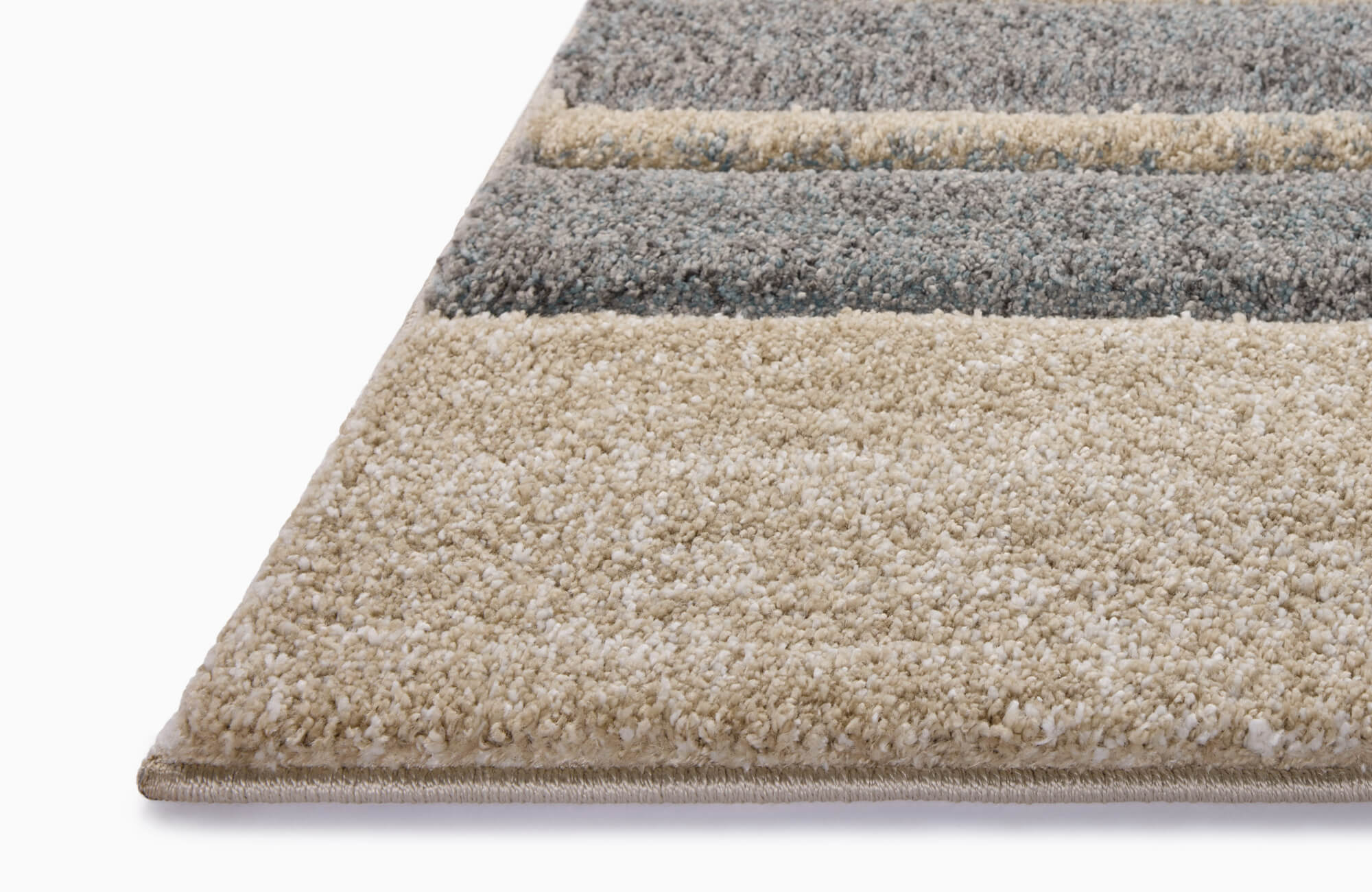 Plush polypropylene area rug with a modern striped pattern in soft beige, cream, and blue-gray hues, offering warmth and texture to any space.
