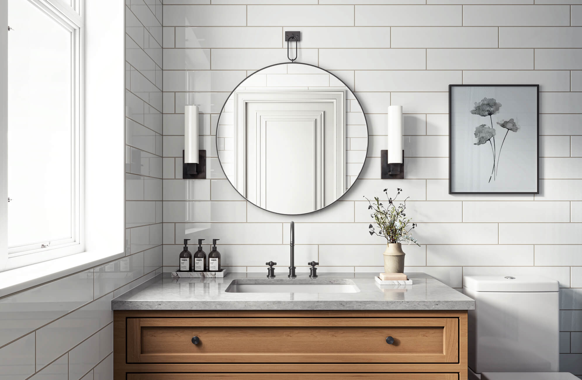 null Bright bathroom with a round, frameless mirror, white subway tiles, light wood vanity, and matte black hardware.