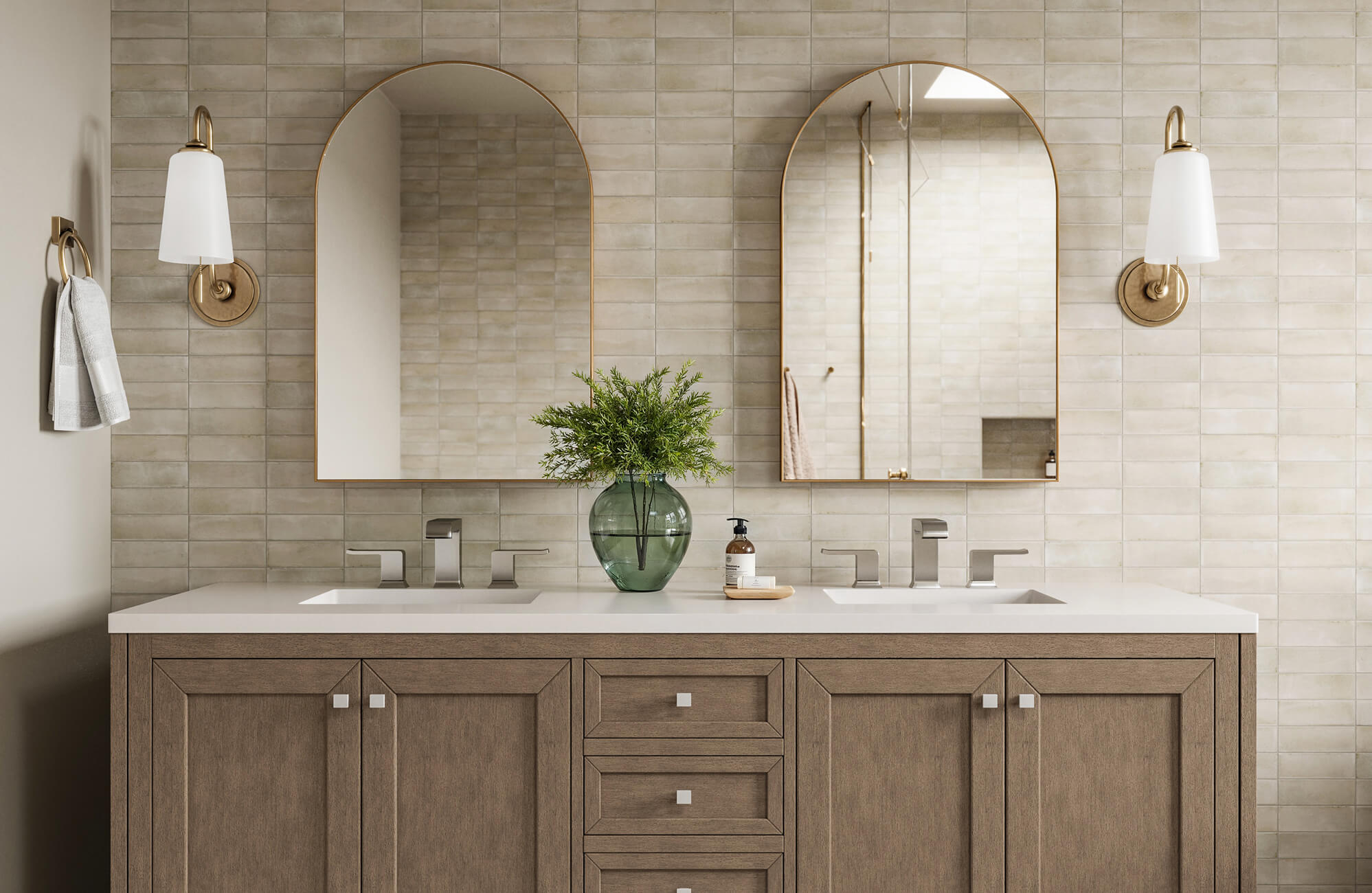 null Refined double vanity with twin arched mirrors, taupe textured tile wall, brushed nickel taps, and brass-accented sconces.