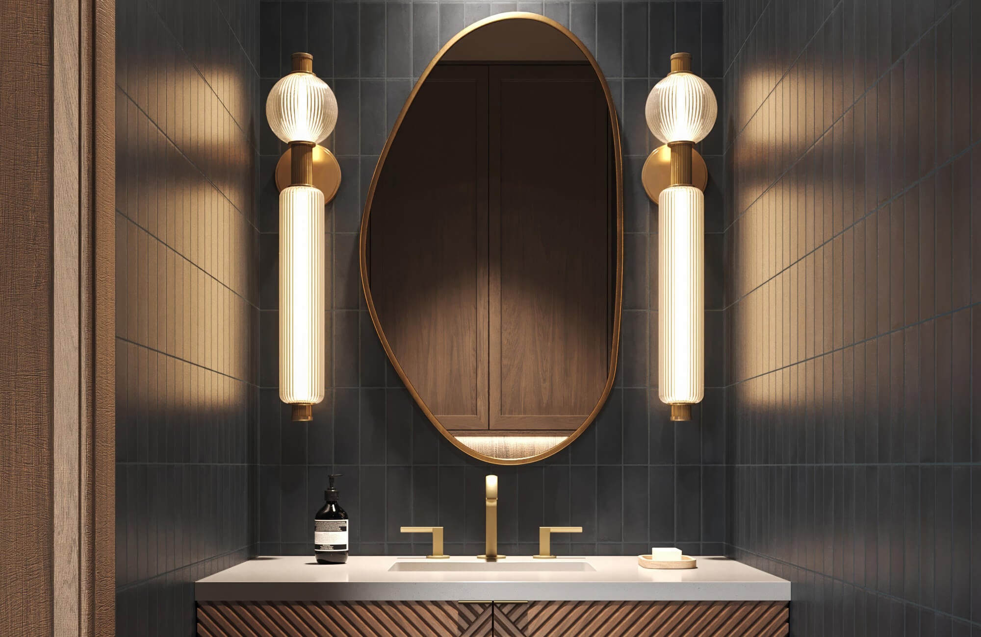 null Dramatic bathroom with a gold-rimmed asymmetrical mirror, deep navy tiles, sculptural lighting, and brushed gold fixtures.