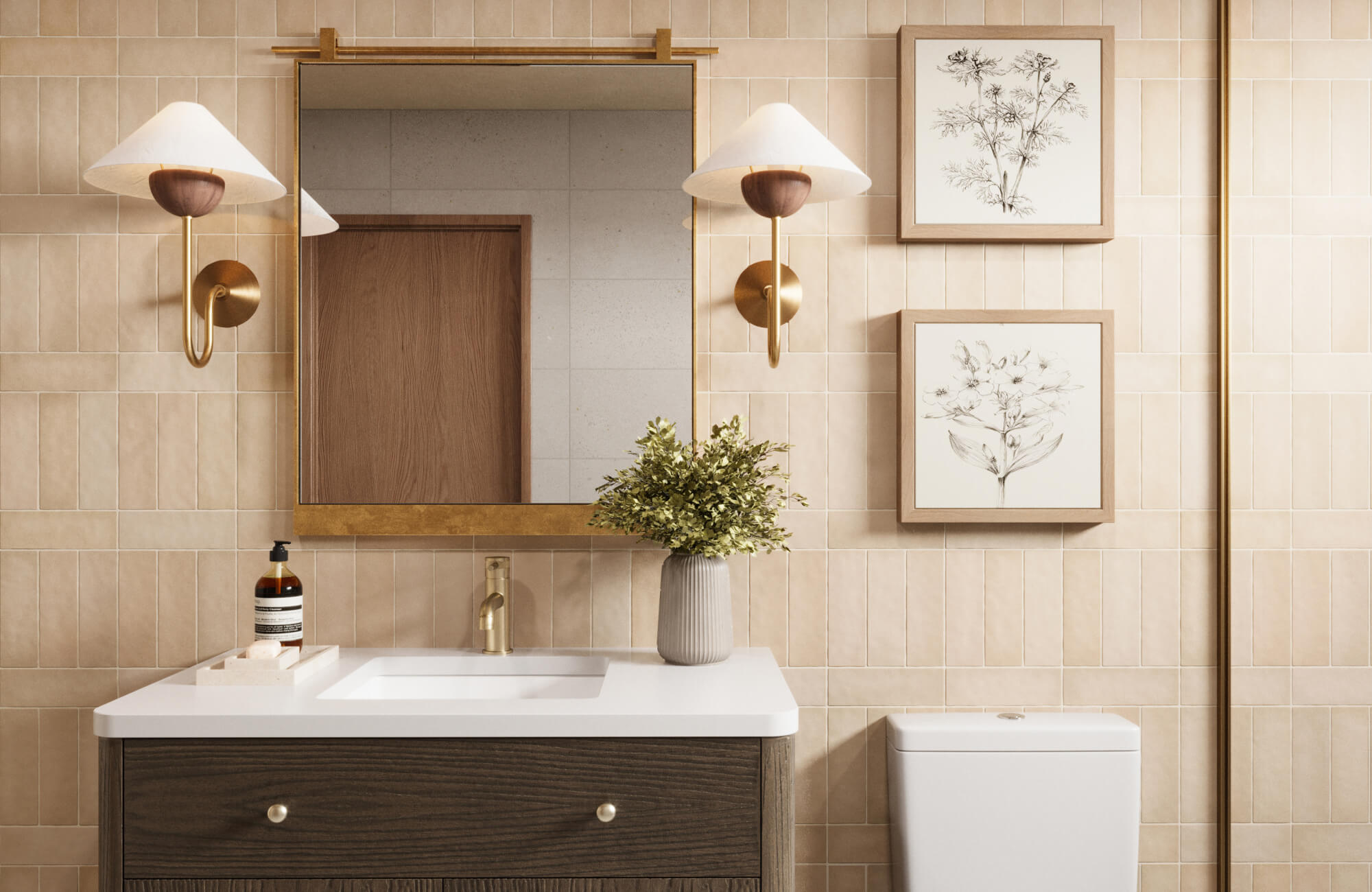 null Warm bathroom with matte beige tiles, brass-accented square mirror, sculptural wall sconces, and botanical prints above a modern toilet.