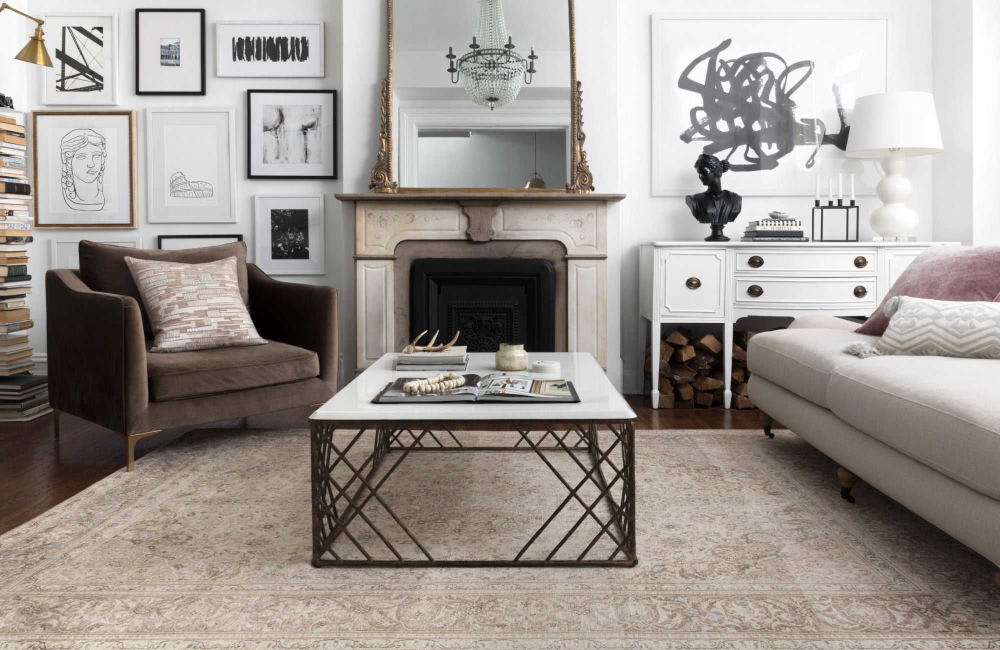 Classic living room with gallery wall, rug aligned with the furniture setup, extending past sofa and chairs for unity.