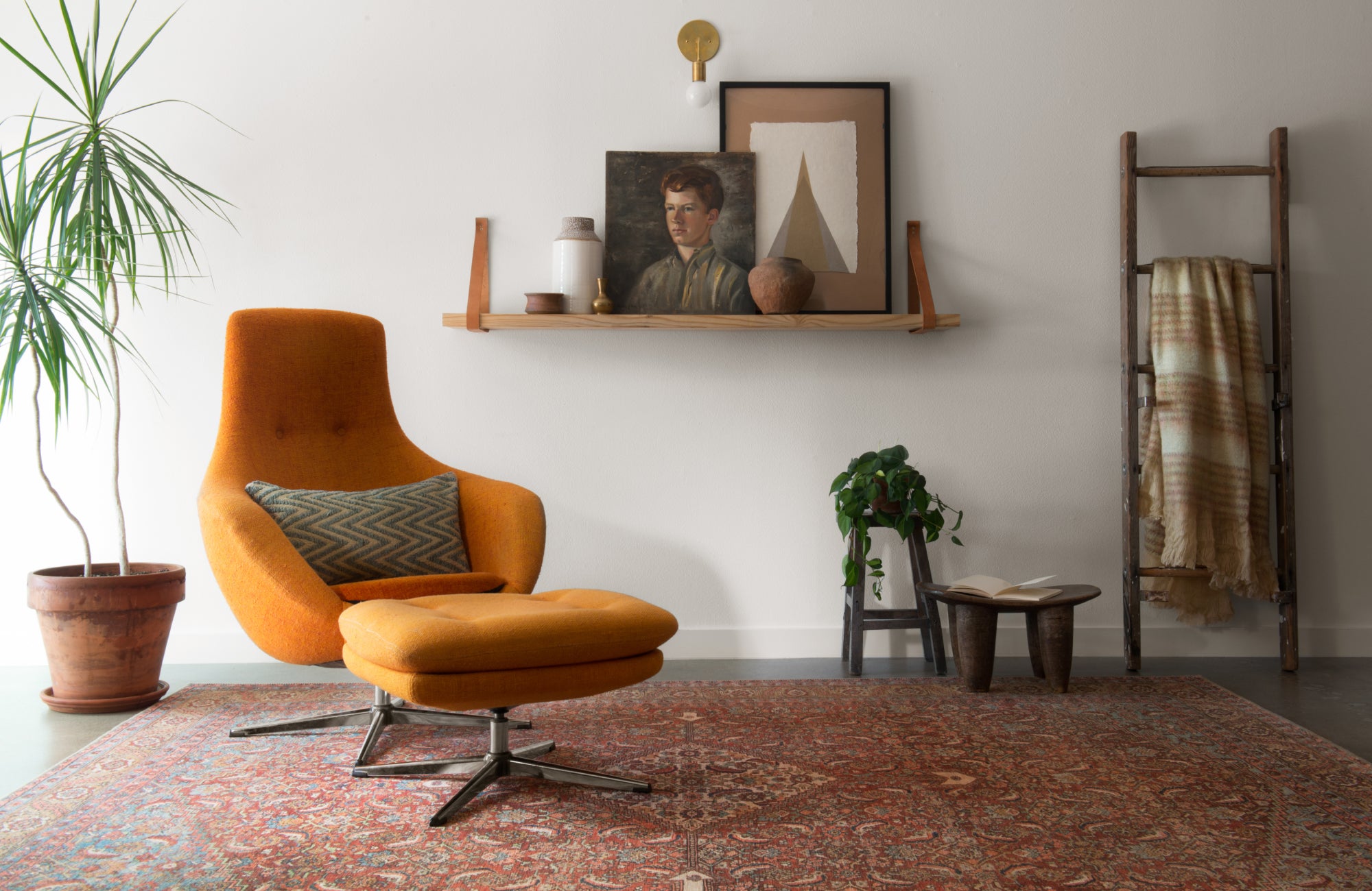 Eclectic corner reading nook with vintage-style rug set at a slight angle to add movement and informal visual rhythm.