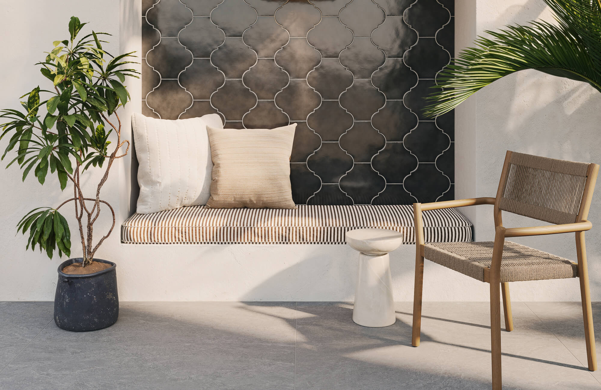 Outdoor-style nook with patterned tile accent wall, striped bench cushion, woven wood chair, and potted greenery.
