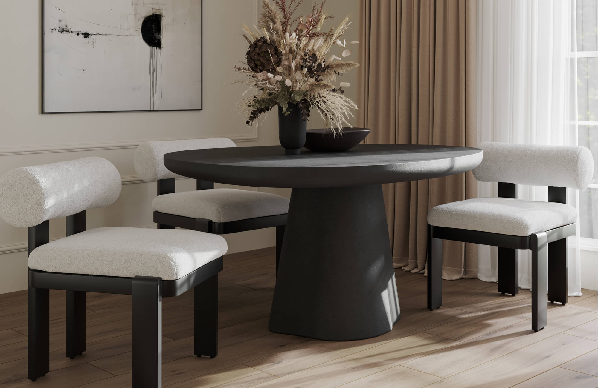 Modern dining area with a black pedestal table, upholstered cream chairs, warm wood floors, and neutral decor.