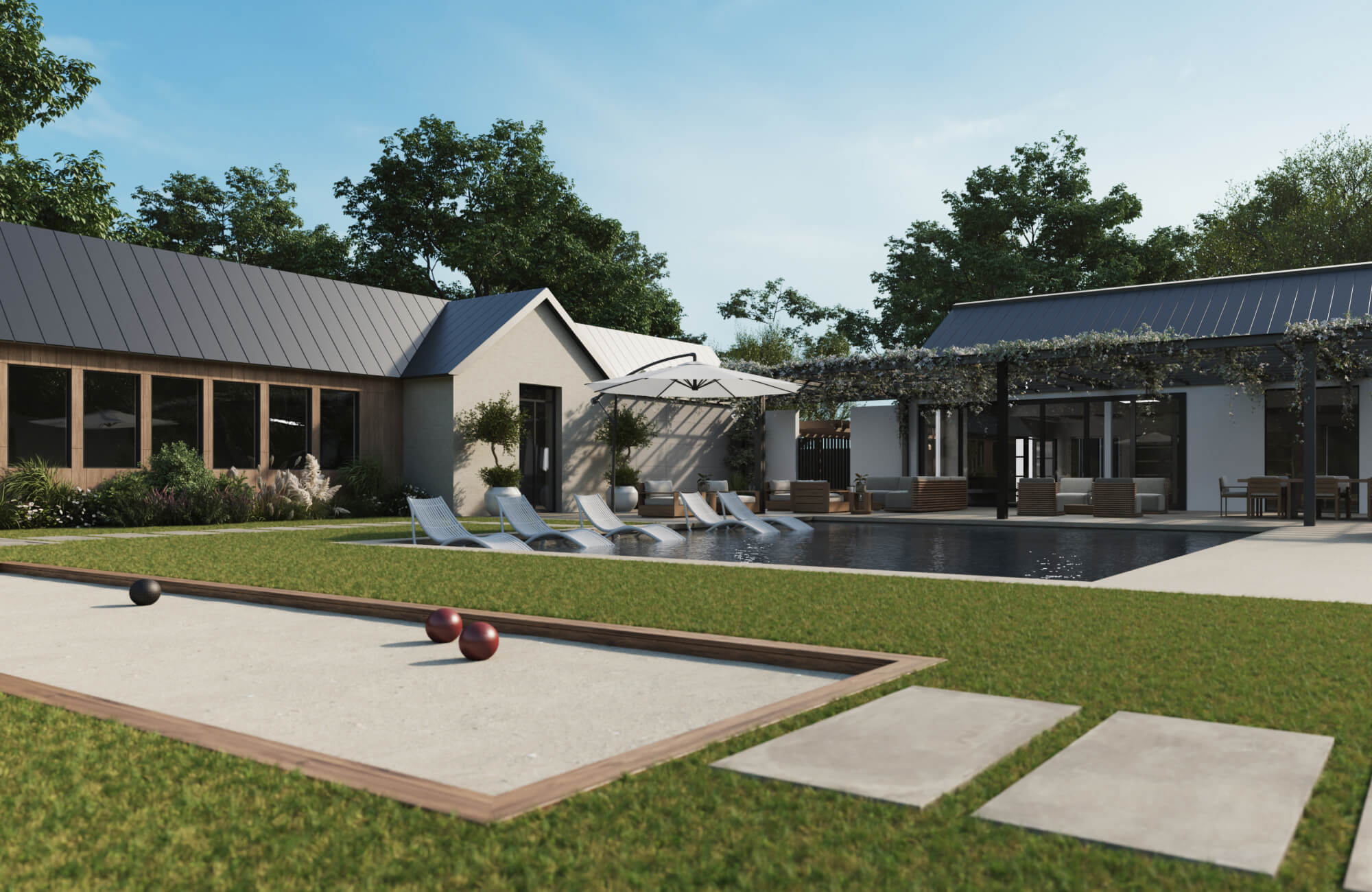 Contemporary poolside patio with large stone-look tiles, lounge chairs, and bocce court in a lush backyard setting.