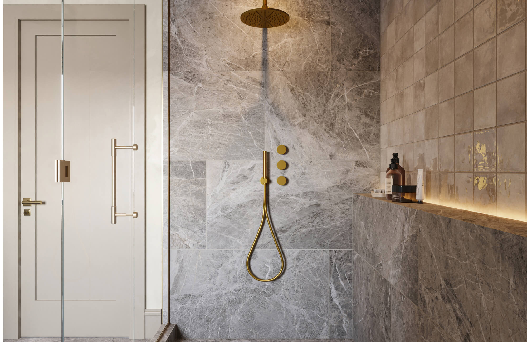 Glass-enclosed shower with gray marble look wall tiles, beige glossy square side tiles, brushed gold rainfall shower fixtures, and a built-in ledge with bath products.