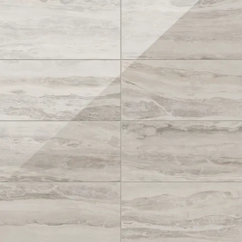Large 12x24 tiles in polished brown, highlighted by intricate natural veining, create a timeless and graceful aesthetic, perfect for elevating any interior.