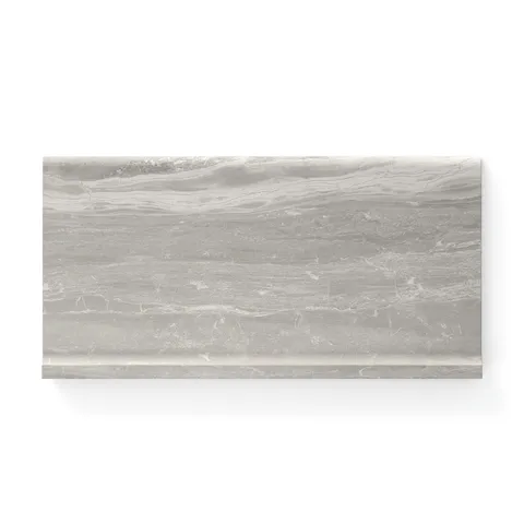6x12 cove base tile highlighting a matte finish with soft taupe hues and delicate natural veining, designed to create a seamless and elegant transition along walls and floors.
