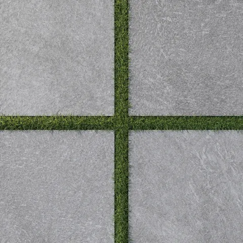 Bowden 24x24 Grip Porcelain 2CM Paver in Slate, featuring sleek gray tones and natural grass accents for a contemporary outdoor look.