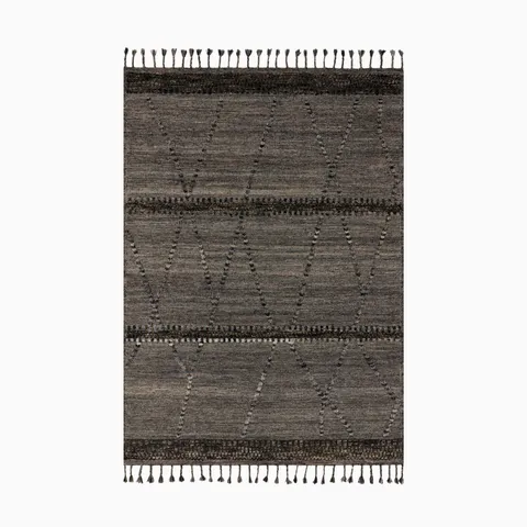 Hand-knotted rug in a wool, cotton, polyester, and rayon blend, featuring deep graphite and espresso tones with a linear pattern and tasseled edges for a sophisticated, contemporary look.