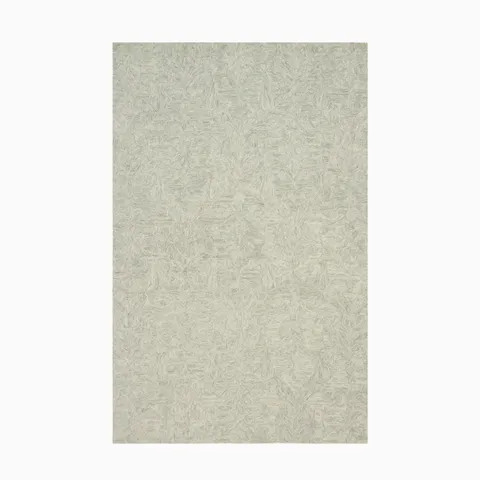 Hooked wool rug in soft aloe green, featuring a tonal border that adds texture and depth to transitional spaces.