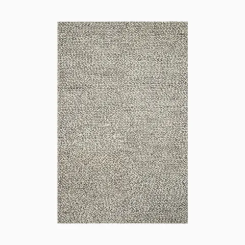 Made from a blend of wool and polyester, this handwoven rug has an ash-gray base with a plush looped texture, ideal for modern spaces.
