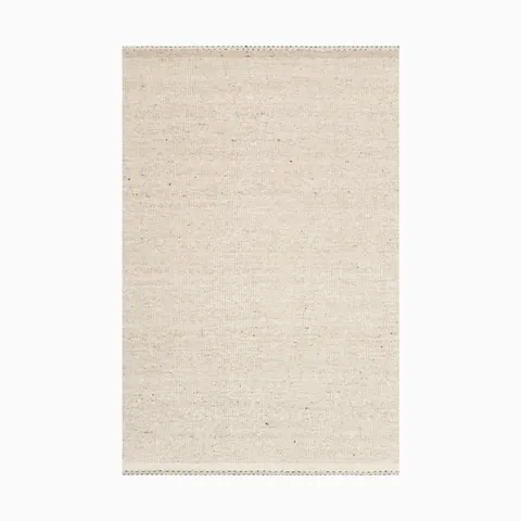 Soft off-white handwoven rug made of wool, cotton, and polyester with a fine, fabric-like texture and subtle speckled details, creating a natural and elegant look.