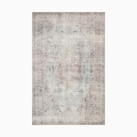 Power-loomed polyester face rug in platinum and mist gray, featuring a distressed transitional medallion pattern for a timeless look.