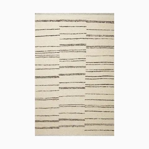 Handwoven rug made of wool, cotton and rayon with an off-white base and abstract black linear pattern, creating a balanced yet dynamic modern design.
