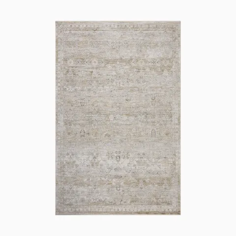 Faded Persian-style power loomed rug in soft beige and ivory tones made of polyester, featuring a distressed medallion pattern for an elegant vintage charm.