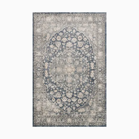 Power loomed area rug made of polypropylene and polyester, featuring an intricate medallion design in distressed blue and ivory tones, exuding timeless elegance.