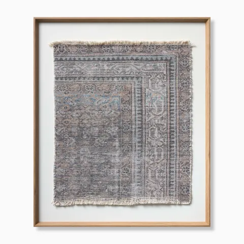 Distressed textile wall art with layered ornamental patterns in warm off-white, taupe, dark gray, and subtle hints of dusty blue.