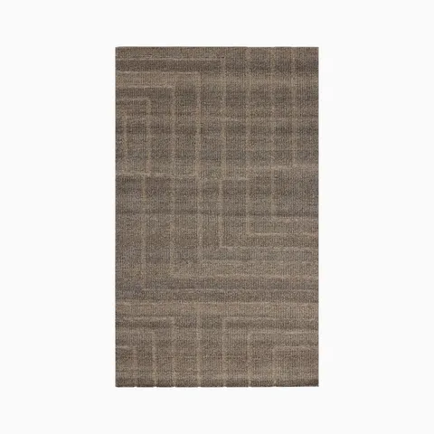Sized at 5'6" x 8'6", this hand-loomed rug combines a brown surface, gentle tonal variation, and angular geometric lines in an eco-friendly wool, cotton, and polyester blend.