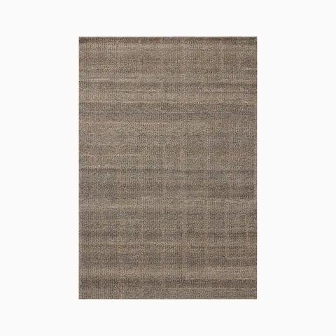 An eco-friendly blend of wool, cotton, and polyester, this 9'6" x 13'6" rug features a brown surface with subtle tonal shifts and angular lines forming a soft geometric pattern.