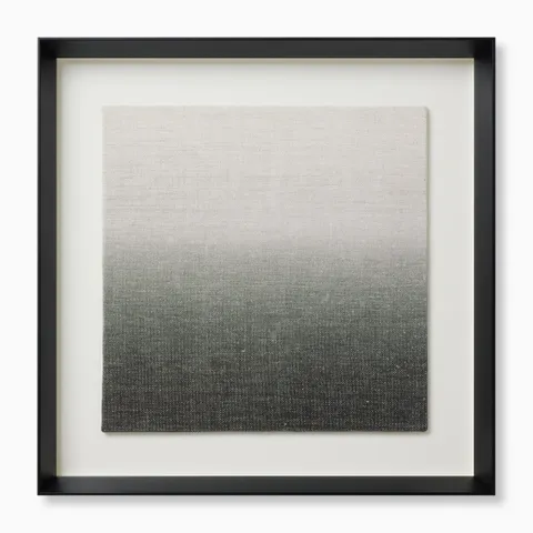 Framed textile art with a soft gradient from pale neutral tones into deeper, earthier shades, adding depth and texture in a sleek black shadowbox frame.