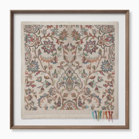 Framed textile artwork featuring a traditional floral motif in rich tones of blue, red, and green, with colorful tassel threads at the bottom.