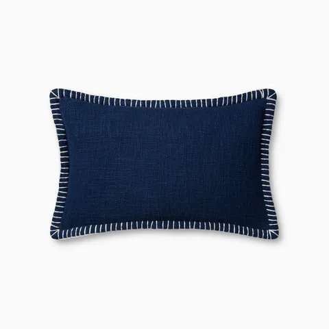 White whipstitching frames this dark blue pillow’s textured weave, while an antique bronze zipper sits hidden behind a tailored flap, finished with a breathable, cool cotton feel.