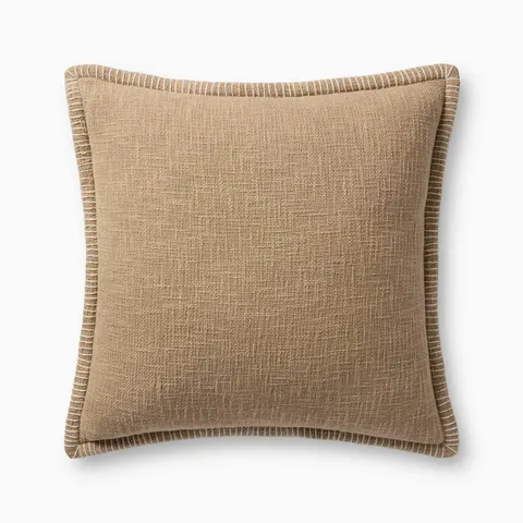 A soft taupe pillow with woven texture, white whipstitched flange edges, and an antique bronze zipper concealed by a tailored flap, finished with a light, breathable cotton feel.