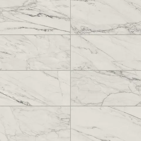 Matte Calacatta Quarzite porcelain marble look tile in 12x24 format, showcasing light grey veining on a white surface for a subtle, modern look.