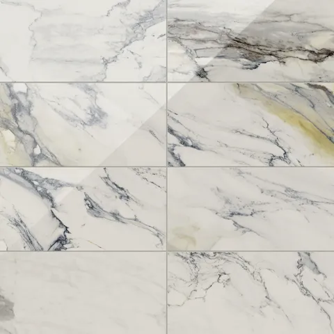Polished Calacatta Antico porcelain marble look tile in 12x24 format, featuring light grey and blue veining with subtle gold accents on a pristine white surface.