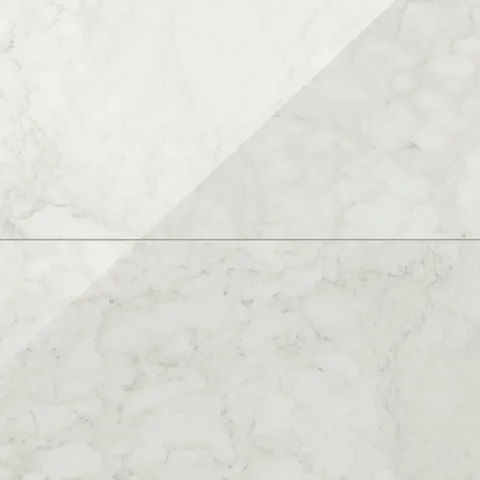 Polished Carrara Bianco marble look tiles with light grey veining on a crisp white surface, offering a classic and timeless look.