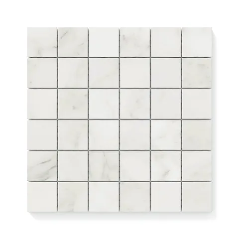Classic white 2x2 Carrara Bianco mosaic marble look tiles with light grey veining on a matte finish, ideal for timeless and elegant spaces.