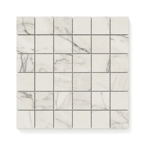 Close-up of 2x2 matte Calacatta marble look mosaic tiles, showcasing light grey veining and a timeless, elegant design perfect for modern interiors.